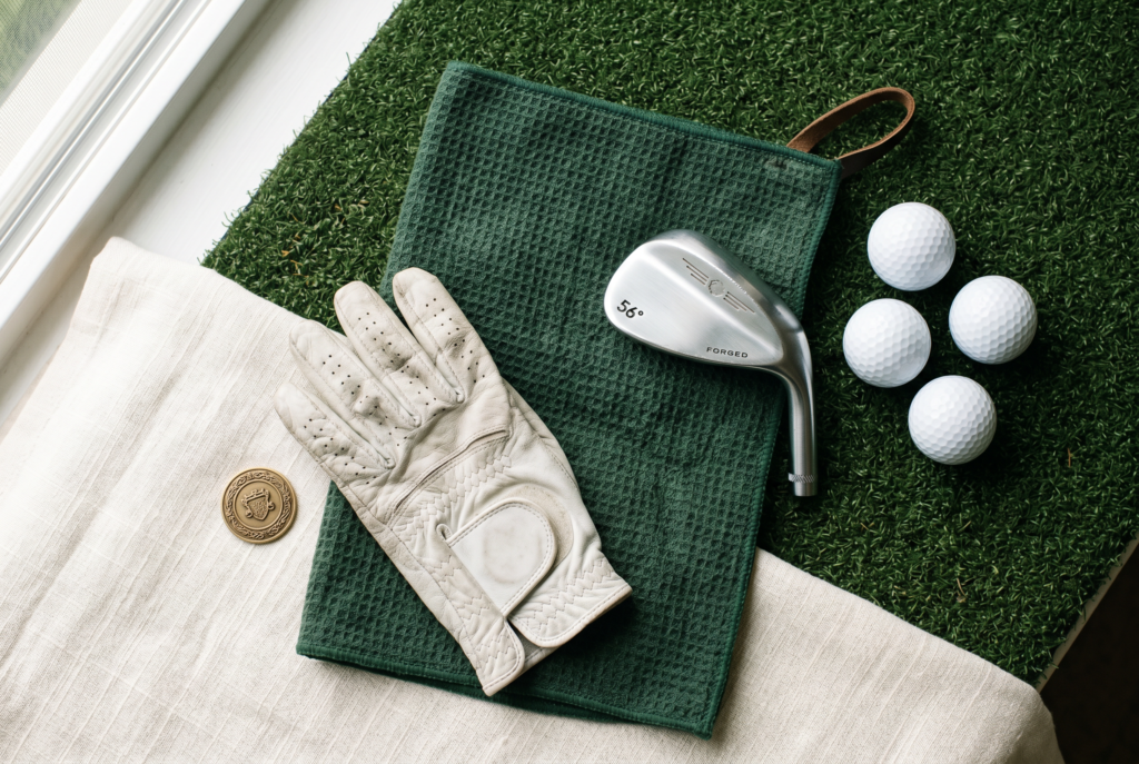 Flat-lay of golf warm-up accessories in classic colours with no text.